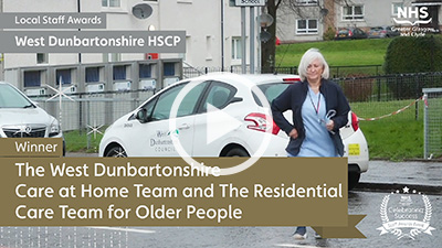 Carer outside block of flats