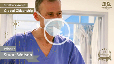 Stuart Watson wearing scrubs and surgical mask
