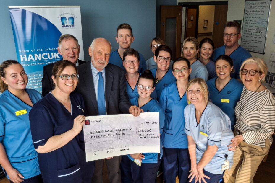 Staff receive a giant cheque for £15,000 from Catherine Clark (right), Peter O'Keefe (back left) and Chris Elkington.