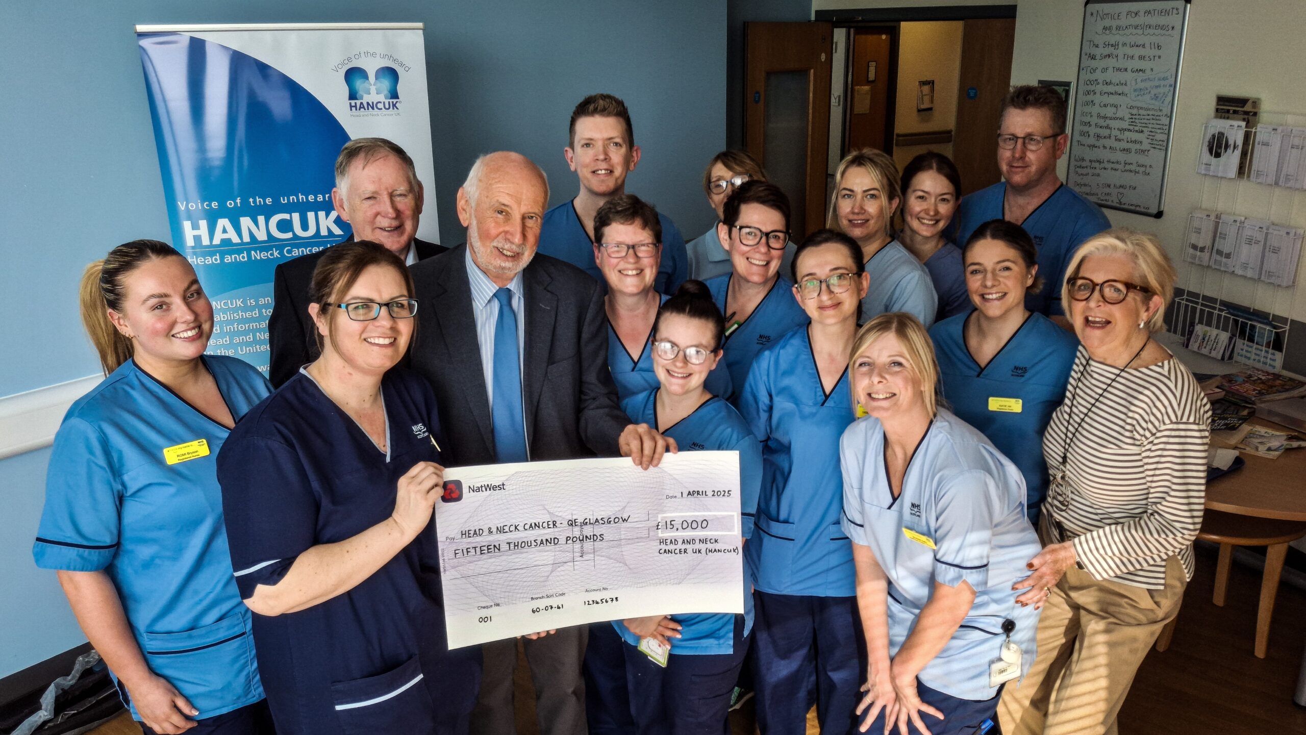 Staff receive a giant cheque for £15,000 from Catherine Clark (right), Peter O'Keefe (back left) and Chris Elkington.