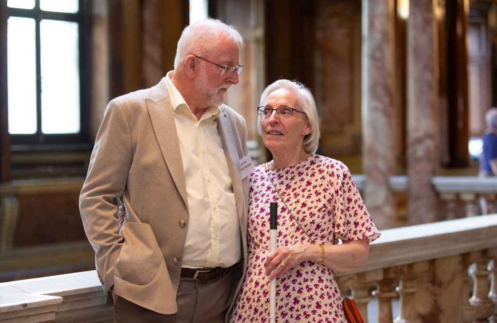 Elizabeth Prior holds her white can and looks at her husband Joe who is standing beside her at Glasgow City Chambers.