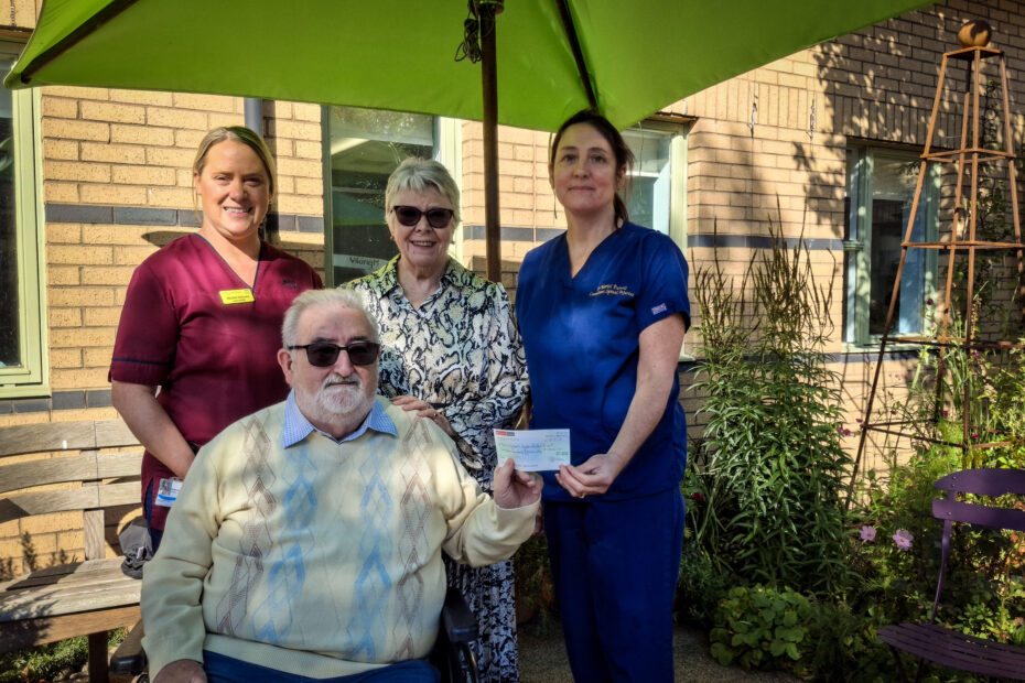Gordon and Valerie Thallon, centre, present their donation to Lead Clinician Dr Mariel Purcell, right, and Lead Nurse Helena Richmond at the National Spinal Injuries Unit.