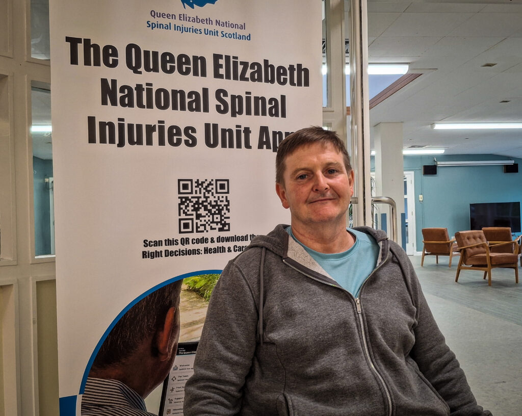 Patient Allan Campbell sits in a wheelchair in the Day Room of the National Spinal Injuries Unit.