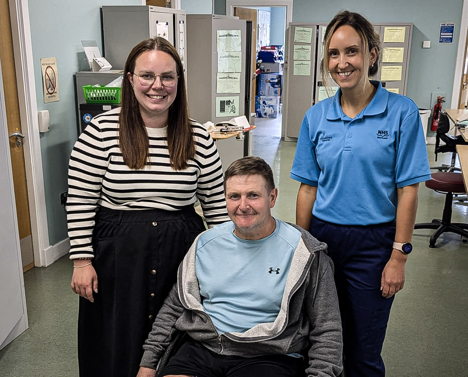 Eve Young of Housing Options Scotland, patient Allan Campbell and Specialist Occupational Therapist Jennifer Cloughley pose for a picture in one of the Spinal Injuries Unit's rehab rooms.