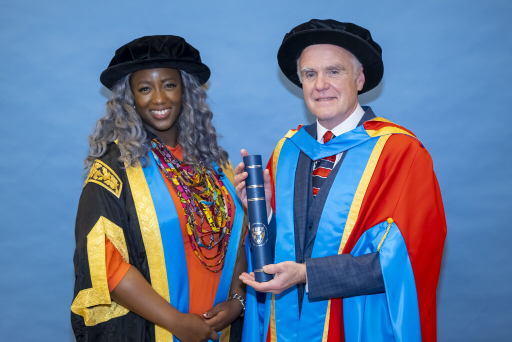 Professor Tom Steele, right, and Dr Anne-Marie Imafidon MBE, Chancellor of Glasgow Caledonian University, stand side by side in their graduation gowns.