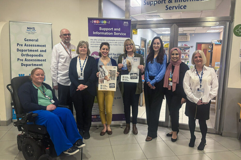 The team from the Support & Information Service line up for a picture outside the service's office in the Queen Elizabeth University Hospital