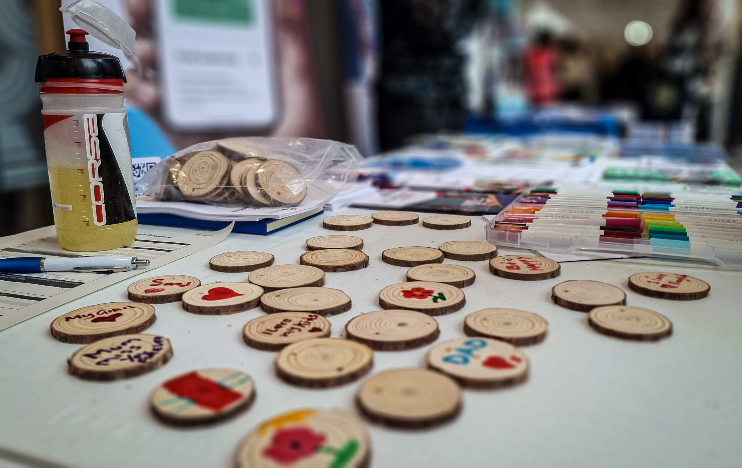 Discs of wood with writing on at the Dementia Heroes stall