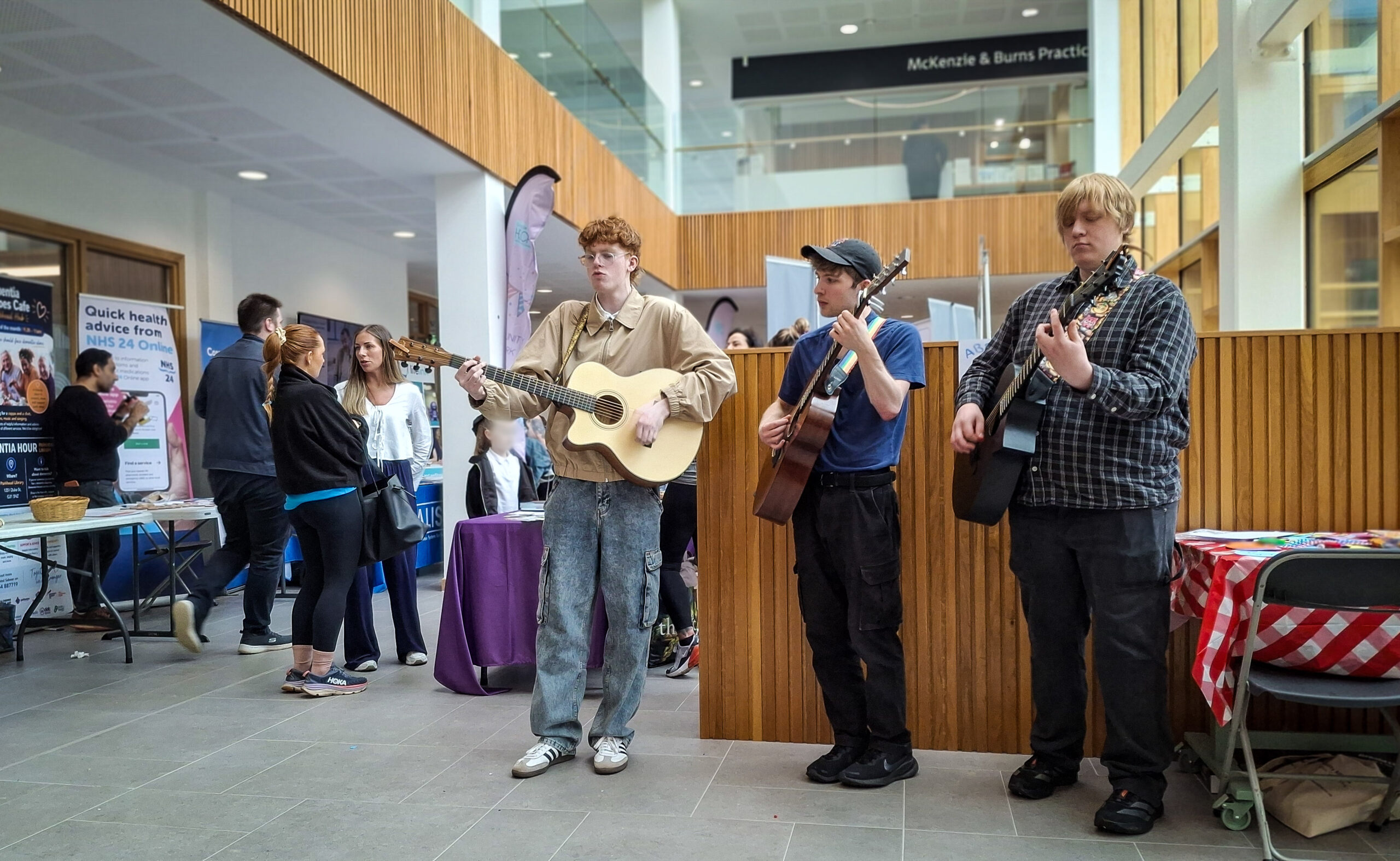 Three musicians play a song at the event.