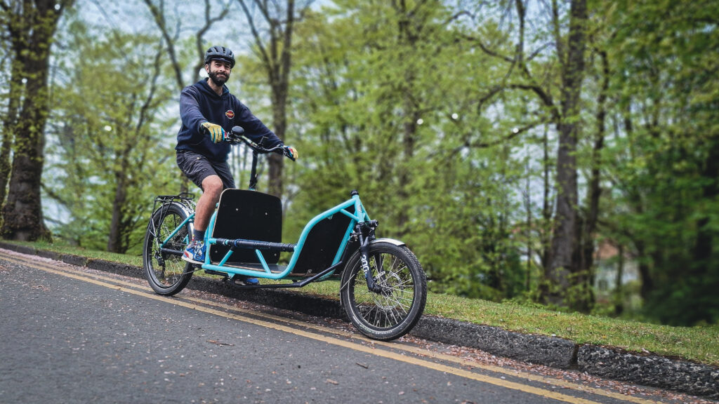 Dr Bike Claudio Pia on his cargo bike, with trees in the background