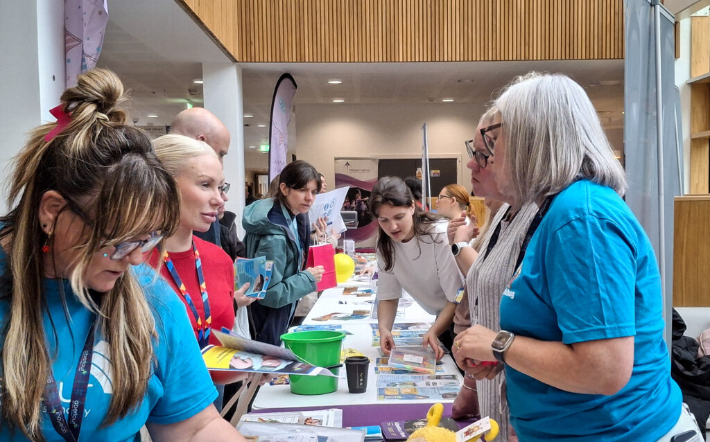 Visitors and stallholders in conversations during the day.