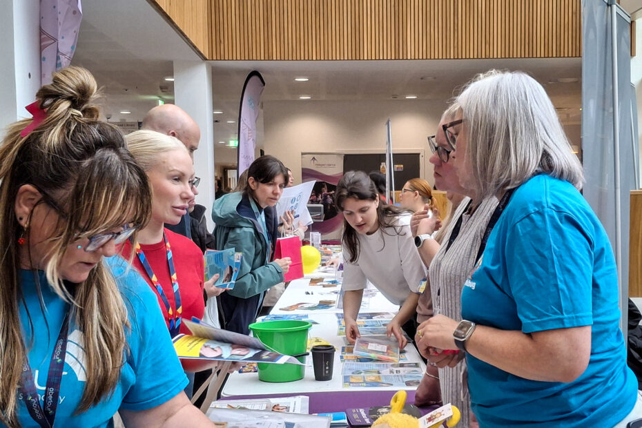 Visitors and stallholders in conversations during the day.