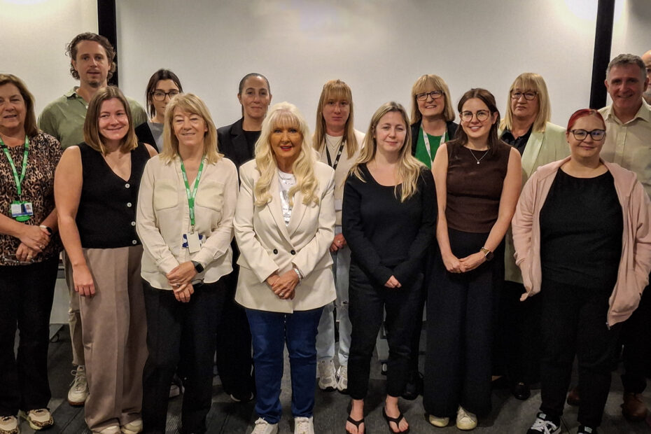 A group of staff and partners standing together for a picture at the partnership event