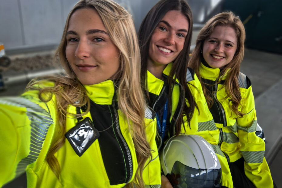 Errin, Amy and Ellie with Danny McInally (left), all wearing yellow hi-vis jackets pose for a selfie taken by Ellie, with Amy and Errin behind her.