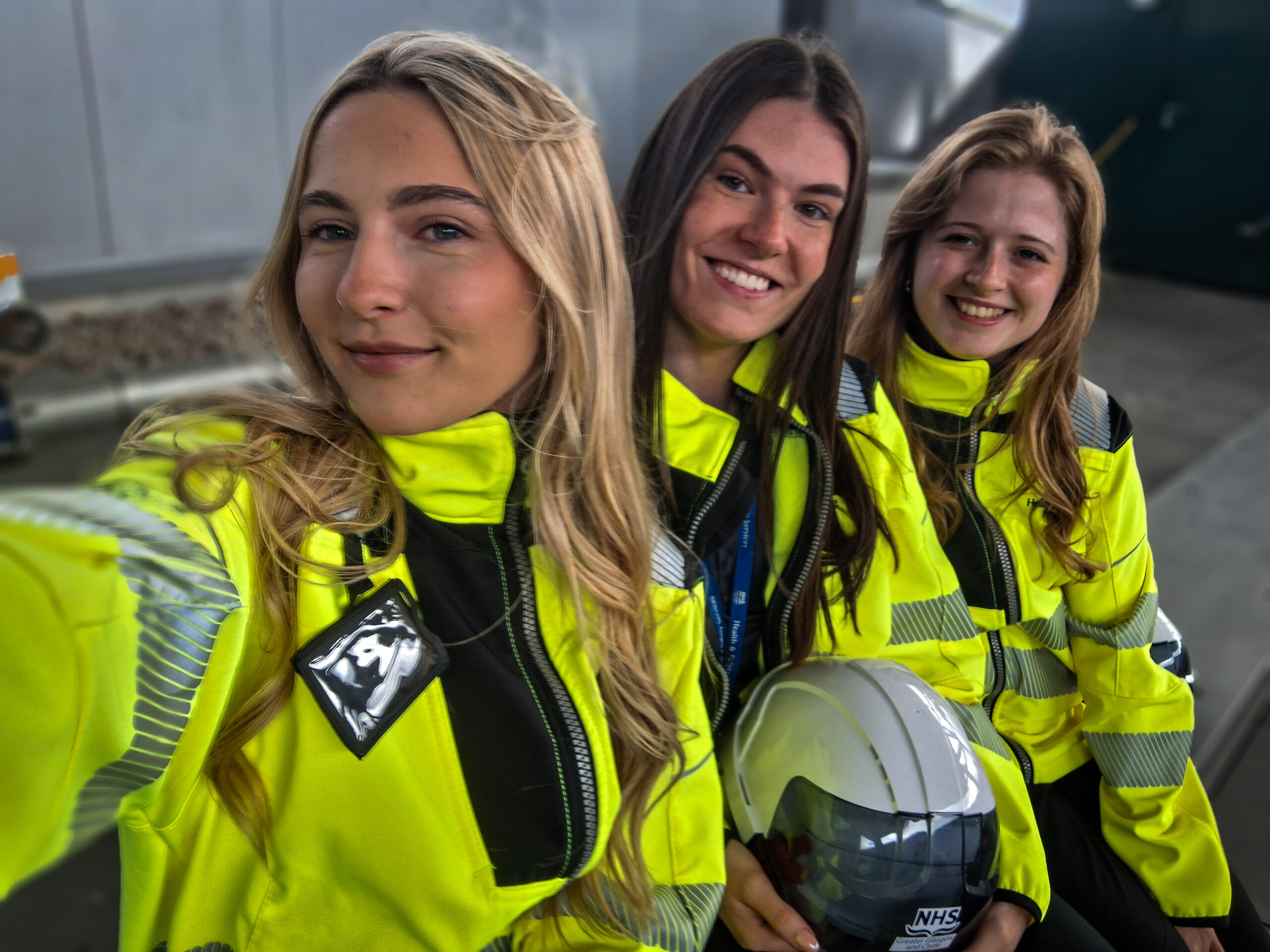 Errin, Amy and Ellie with Danny McInally (left), all wearing yellow hi-vis jackets pose for a selfie taken by Ellie, with Amy and Errin behind her.