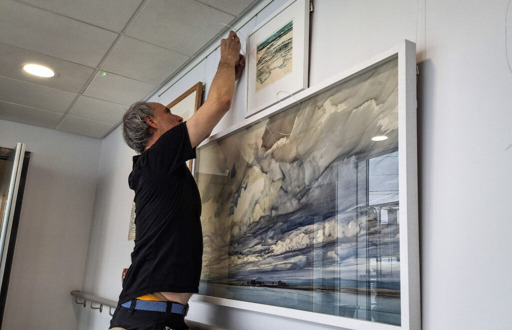 One of the art handlers hard at work installing the exhibition at the New Victoria Hospital.