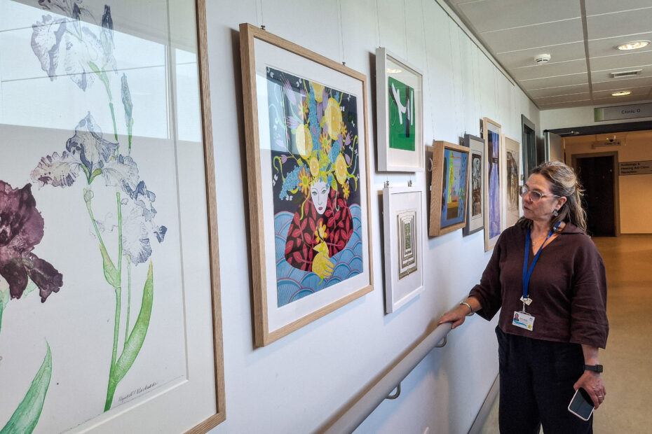 Staff member Jackie Sands admires some of the works on display at the New Victoria Hospital.