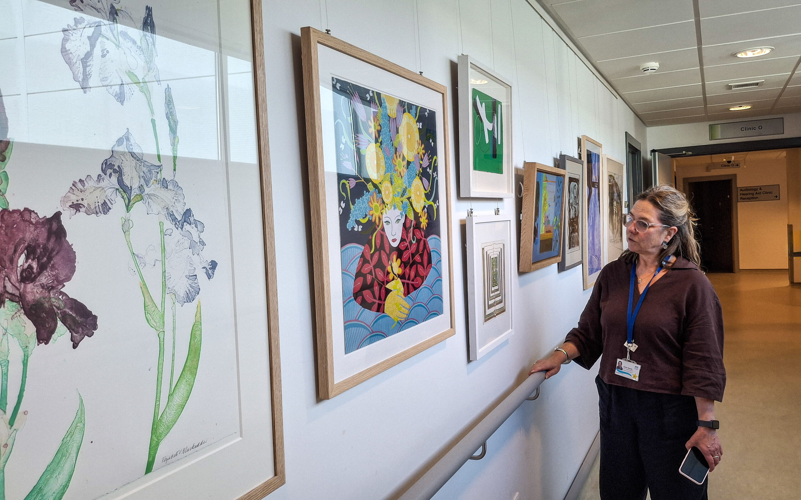 Staff member Jackie Sands admires some of the works on display at the New Victoria Hospital.