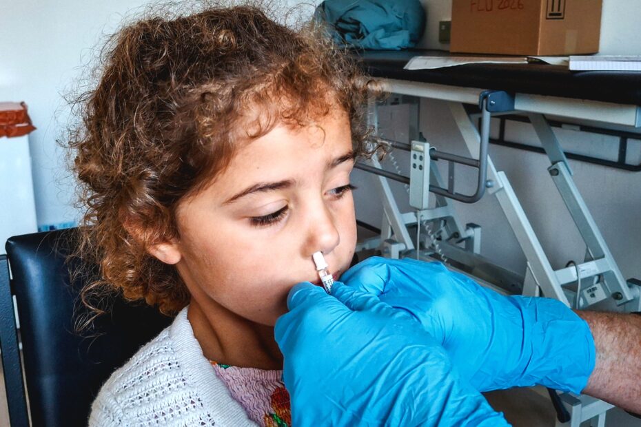 Four-year-old Matilda Rughani is given the flu vaccine at a clinic in Glasgow
