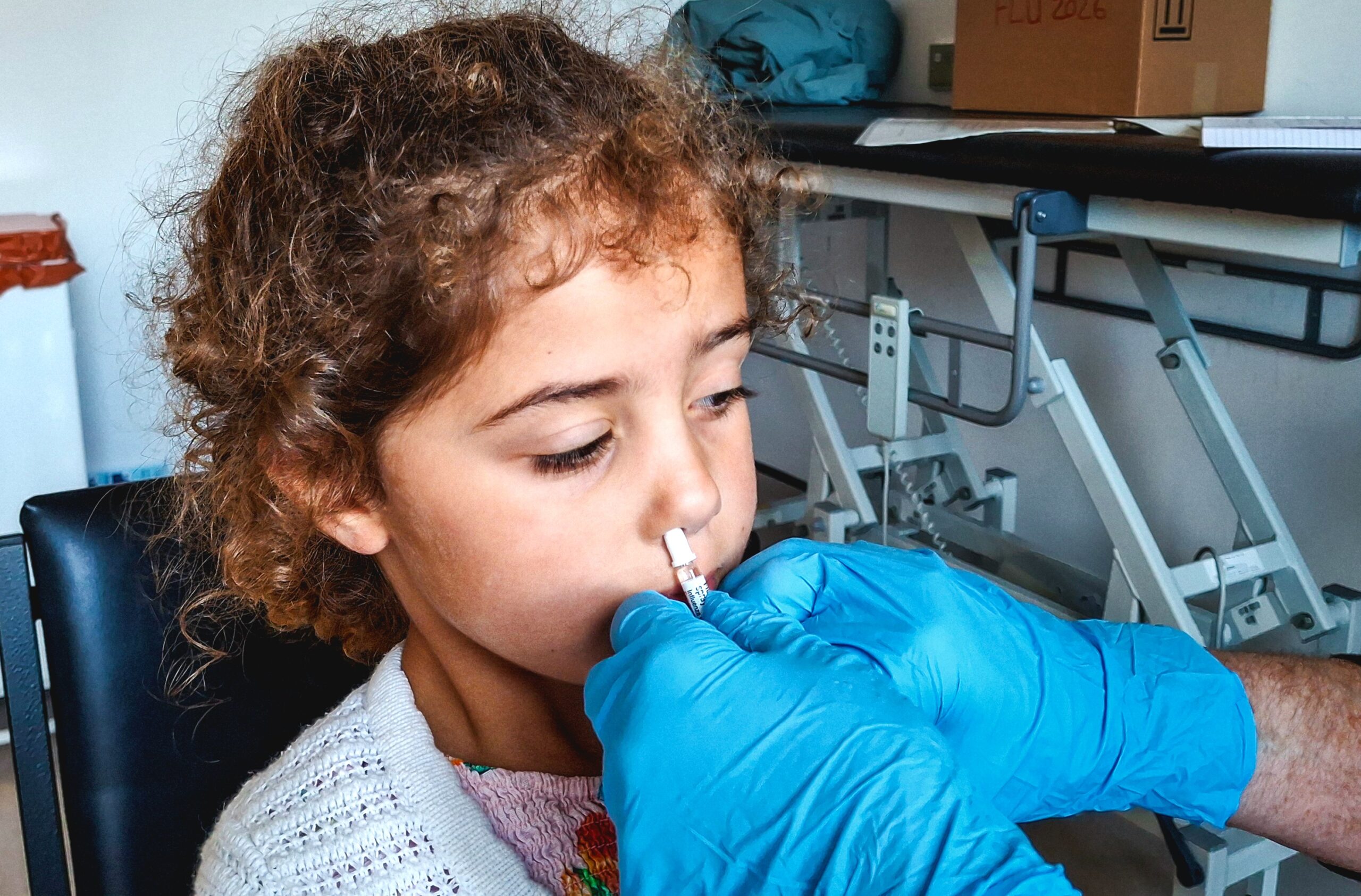 Four-year-old Matilda Rughani is given the flu vaccine at a clinic in Glasgow