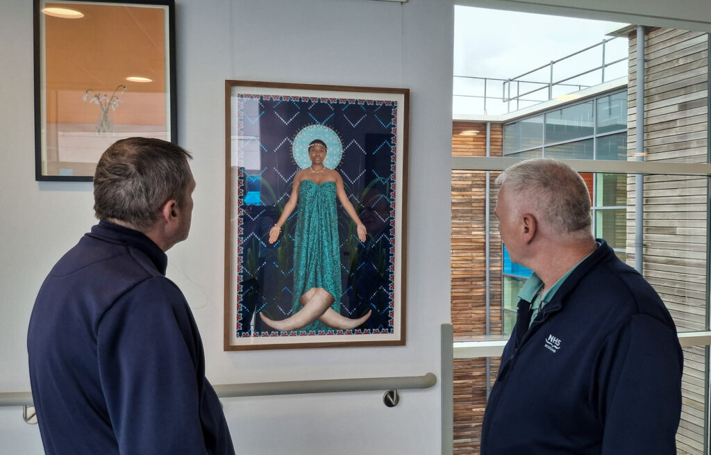 Staff stop and look at one of the works at the New Victoria Hospital.